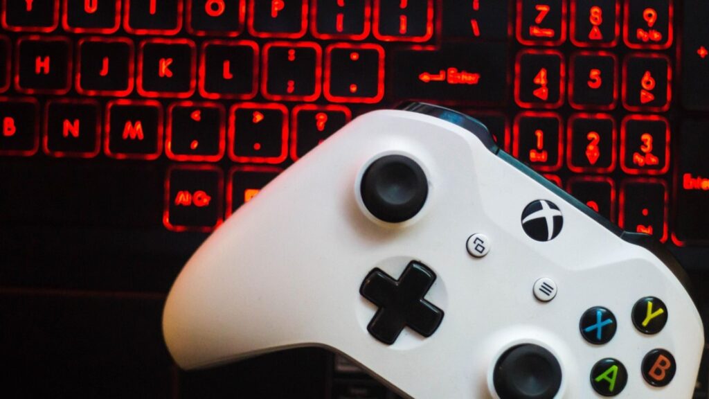 Controle de VideoGame sobre teclado aceso controlam as mesmas telas.